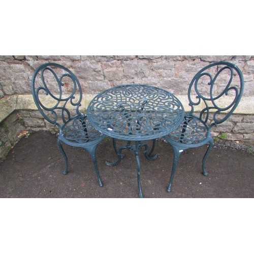 1003 - A decorative three piece painted cast aluminium garden terrace set with open and pierced scrolled de... 