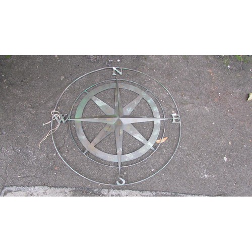 1062 - A contemporary copper verdigris radiating star compass, 80cm diameter