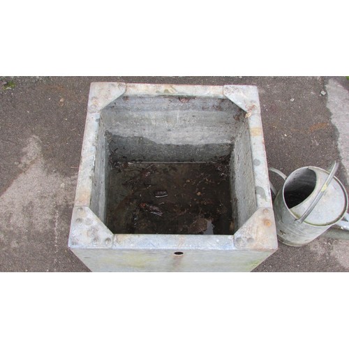 1015 - A square galvanised steel water tank with pop rivetted seems, 52cm square, together with a watering ... 