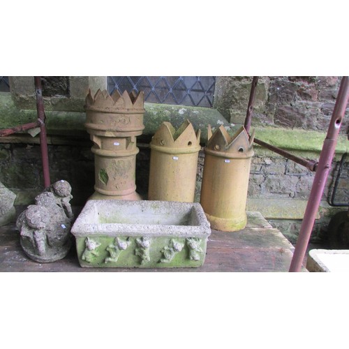 1021 - A weathered rectangular cast stone trough with repeating cherub detail, together with three buff col... 