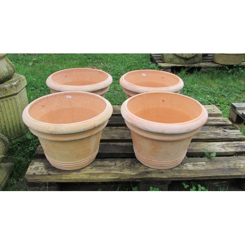 1011 - Four contemporary terracotta pots of circular tapered and ribbed form, 28cm high x 41cm diameter