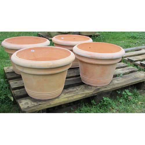 1011 - Four contemporary terracotta pots of circular tapered and ribbed form, 28cm high x 41cm diameter