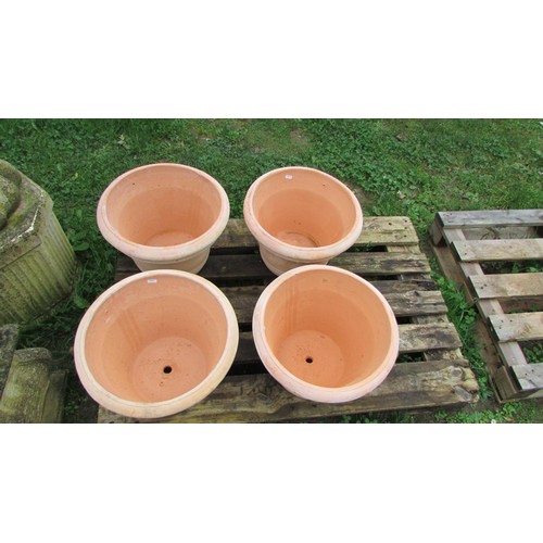 1011 - Four contemporary terracotta pots of circular tapered and ribbed form, 28cm high x 41cm diameter