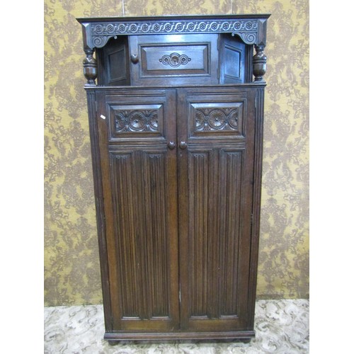 1143 - A reproduction old English style oak freestanding side cupboard partially enclosed by a pair of thre... 