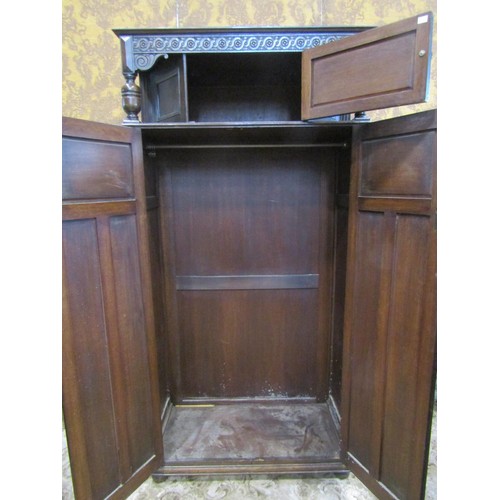 1143 - A reproduction old English style oak freestanding side cupboard partially enclosed by a pair of thre... 