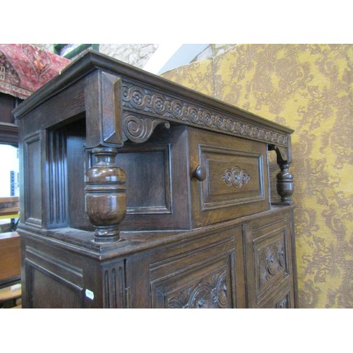 1143 - A reproduction old English style oak freestanding side cupboard partially enclosed by a pair of thre... 