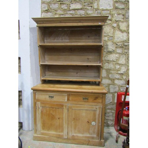 1144 - A stripped pine kitchen dresser the lower section enclosed by  two drawers and bi-fold cupboard door... 