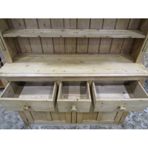 1147 - A stripped pine farmhouse kitchen dresser the base enclosed by a pair of panelled doors and three fr... 