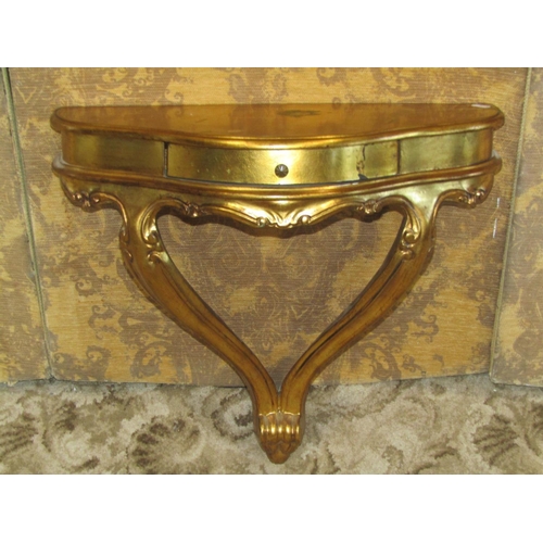 1151 - A small gilt wood console table, the serpentine front fitted with a frieze drawer, raised on shaped ... 