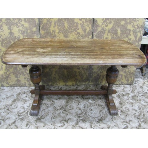 1155 - A 1930s oak refectory table, with D shaped ends, raised on baluster supports, 73cm high x 150cm long... 