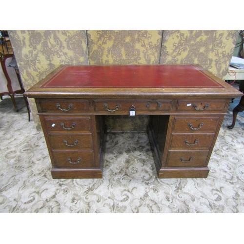 1156 - An oak pedestal desk in the Georgian style with inset leather panelled top over nine frieze drawers,... 