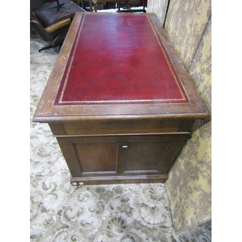 1156 - An oak pedestal desk in the Georgian style with inset leather panelled top over nine frieze drawers,... 