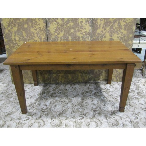 1162 - A pine kitchen table the rectangular top raised on four square tapered supports, 78 cm high x 152 cm... 