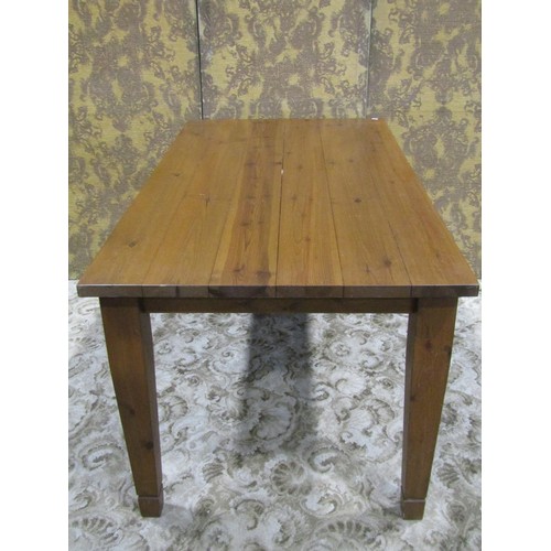 1162 - A pine kitchen table the rectangular top raised on four square tapered supports, 78 cm high x 152 cm... 