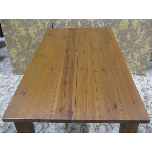 1162 - A pine kitchen table the rectangular top raised on four square tapered supports, 78 cm high x 152 cm... 