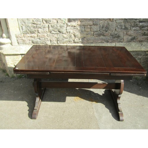 1167 - A dark stained refectory table raised on shaped supports and sledge feet united by a pegged rails, (... 