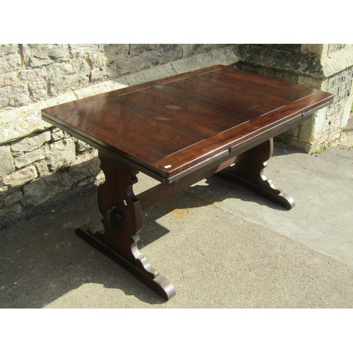 1167 - A dark stained refectory table raised on shaped supports and sledge feet united by a pegged rails, (... 