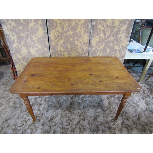 1168 - A pine rectangular kitchen table with central frieze drawer raised on turned supports, 74cm high x 1... 