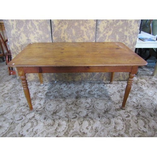 1168 - A pine rectangular kitchen table with central frieze drawer raised on turned supports, 74cm high x 1... 