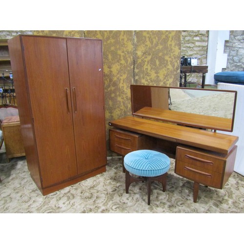 1169 - A G Plan teak bedroom pair comprising a two door wardrobe and a kneehole dressing table with floatin... 