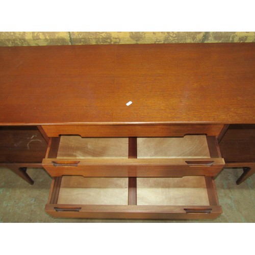 1153 - An A Younger Ltd mid-20th century teak dining room suite comprising a long sideboard, 75cm high x 21... 