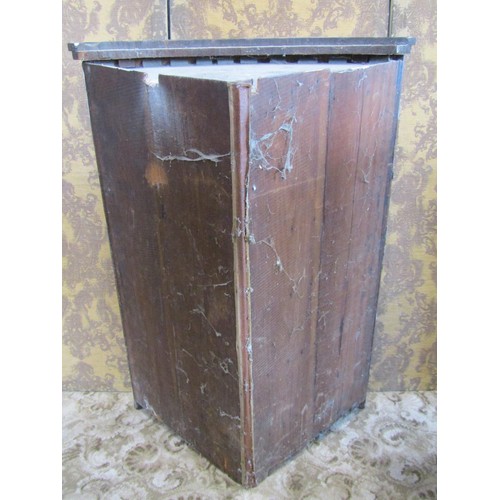 1138 - An early 19th century mahogany bow fronted hanging corner cupboard enclosed by two doors over one re... 