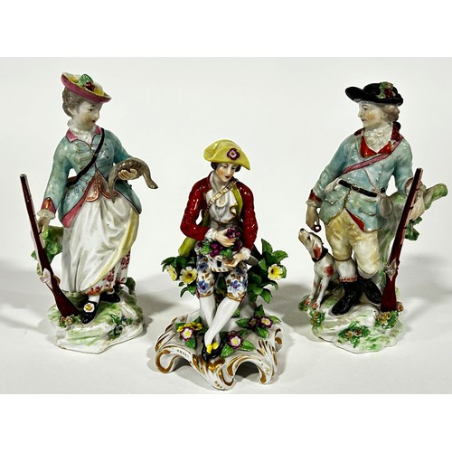 88 - A pair of Derby porcelain figures, sporting couple, 16cm high, together with a further porcelain fig... 