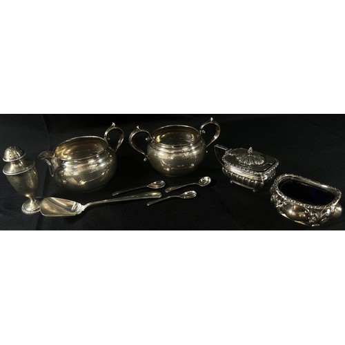 220 - A selection of silverware including a sugar bowl, milk jug, caddy spoon, pepper pot, condiments and ... 