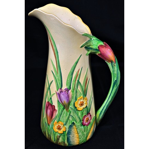 102 - A Carltonware ewer with moulded floral detail, 26cm high, together with a Crown Devon vase, 20cm hig... 