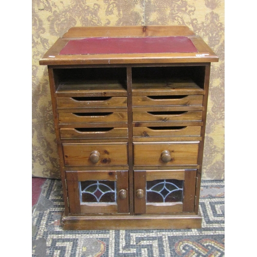 1179 - A contemporary stained pine side cabinet or counter with inset faux leather panel top over an arrang... 