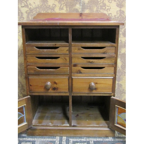 1179 - A contemporary stained pine side cabinet or counter with inset faux leather panel top over an arrang... 