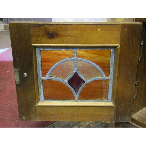 1179 - A contemporary stained pine side cabinet or counter with inset faux leather panel top over an arrang... 