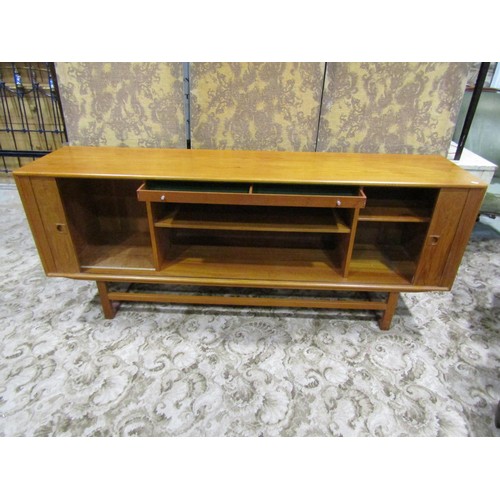 1181 - A retro teak sideboard enclosed by a pair of sliding doors, with loose paper label to interior, The ... 