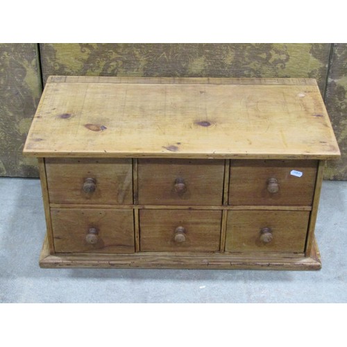 1184 - A small stripped pine counter top chest of six drawers with mahogany fronts, 33cm high x 65cm x 35cm