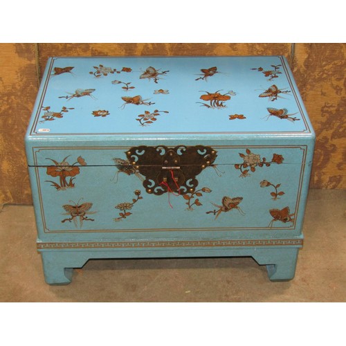 1189 - A contemporary Chinese chest with hinged lid and decorative floral and butterfly detail on a turquoi... 