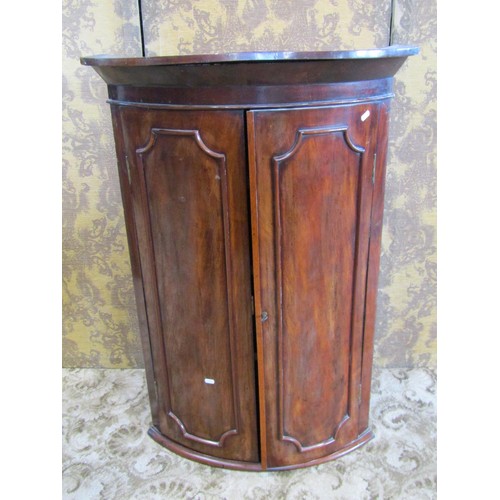 1195 - 19th century mahogany bow fronted hanging corner cupboard, enclosed by a pair of moulded panelled do... 