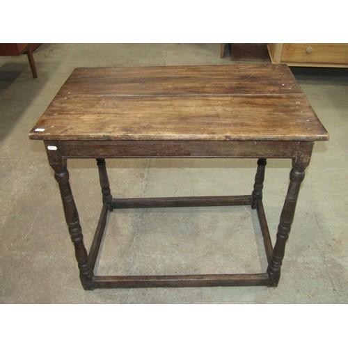 1200 - An 18th century oak occasional table of rectangular form with turned supports, united by stretchers,... 