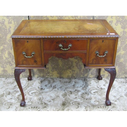 1203 - An Edwardian Georgian style kneehole writing table with inset leather top, over three frieze drawers... 