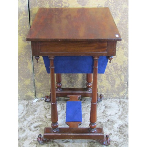 1208 - A 19th century mahogany sewing table fitted with one real and one dummy frieze drawer, raised on tur... 