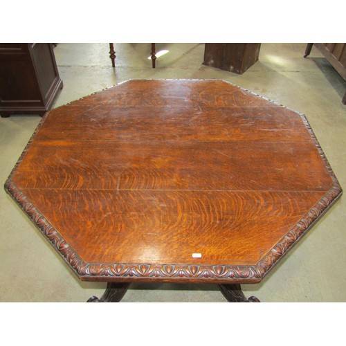 1212 - A Victorian oak centre table with octagonal top raised on spiral twist columns, set on a shaped plat... 