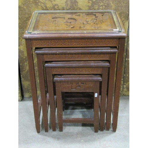 1213 - A Chinese hard wood quartetto nest of tables with carved detail and plate glass tops, the largest 66... 