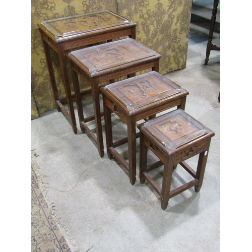 1213 - A Chinese hard wood quartetto nest of tables with carved detail and plate glass tops, the largest 66... 