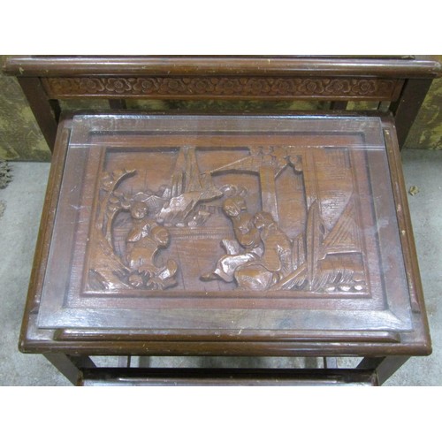 1213 - A Chinese hard wood quartetto nest of tables with carved detail and plate glass tops, the largest 66... 