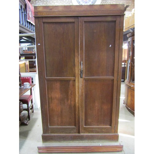 1216 - An Edwardian oak pantry cupboard enclosed by a pair of full length doors, with shelved interior (af)... 