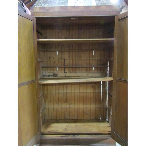 1216 - An Edwardian oak pantry cupboard enclosed by a pair of full length doors, with shelved interior (af)... 