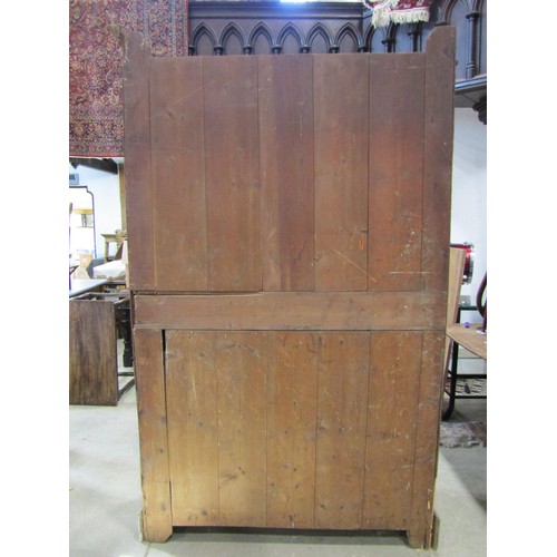 1216 - An Edwardian oak pantry cupboard enclosed by a pair of full length doors, with shelved interior (af)... 