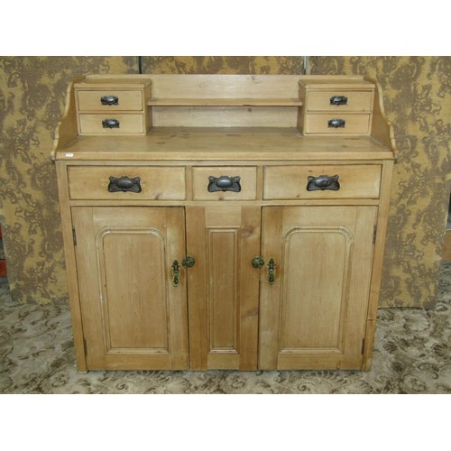 1218 - A antique stripped pine kitchen dresser enclosed by an arrangement of cupboards and drawers, 112cm h... 