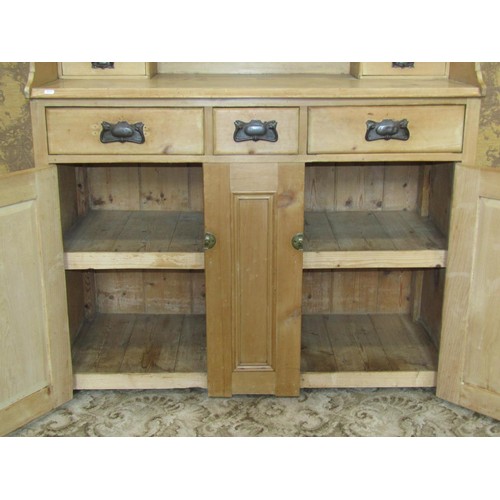 1218 - A antique stripped pine kitchen dresser enclosed by an arrangement of cupboards and drawers, 112cm h... 