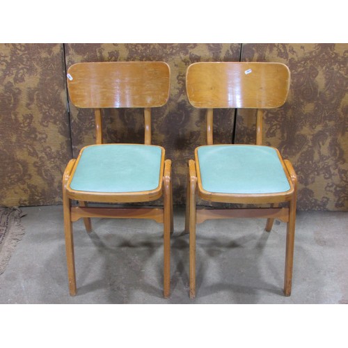 1225 - A pair of retro stained beechwood chairs with upholstered pad seats raised on tapered splay supports