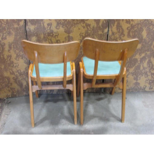 1225 - A pair of retro stained beechwood chairs with upholstered pad seats raised on tapered splay supports